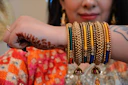 A woman with a bunch of bracelets on her arm