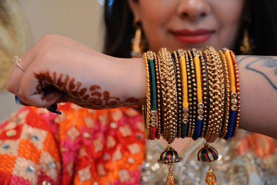 A woman with a bunch of bracelets on her arm