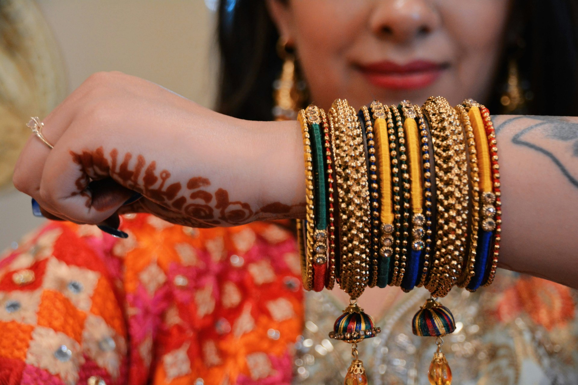 A woman with a bunch of bracelets on her arm