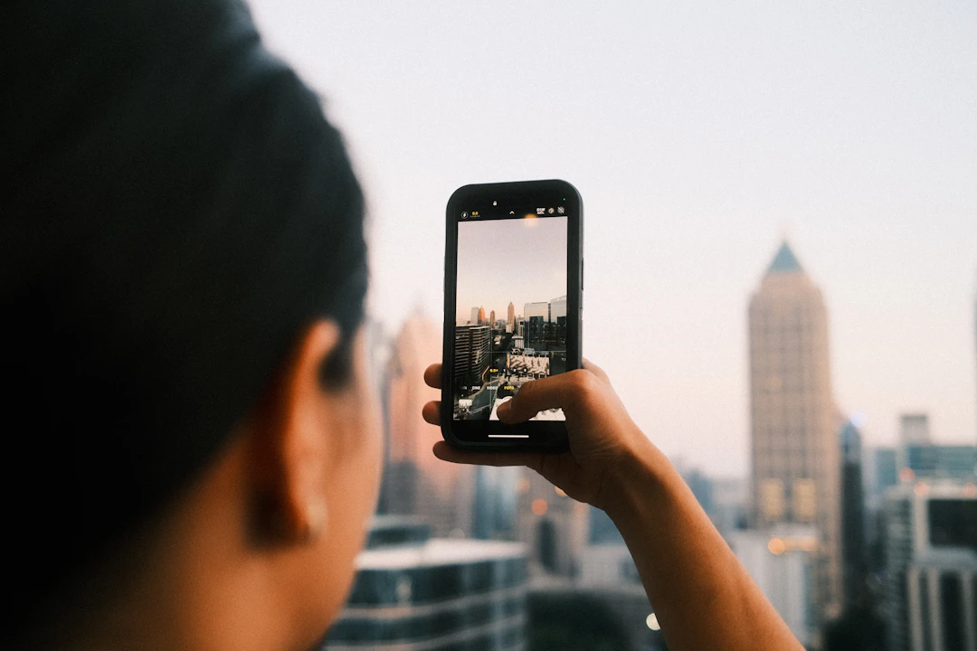 Capturing a city skyline on a phone at golden hour — the moment of entry, anywhere