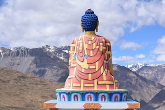 A large buddha statue sitting on top of a hill