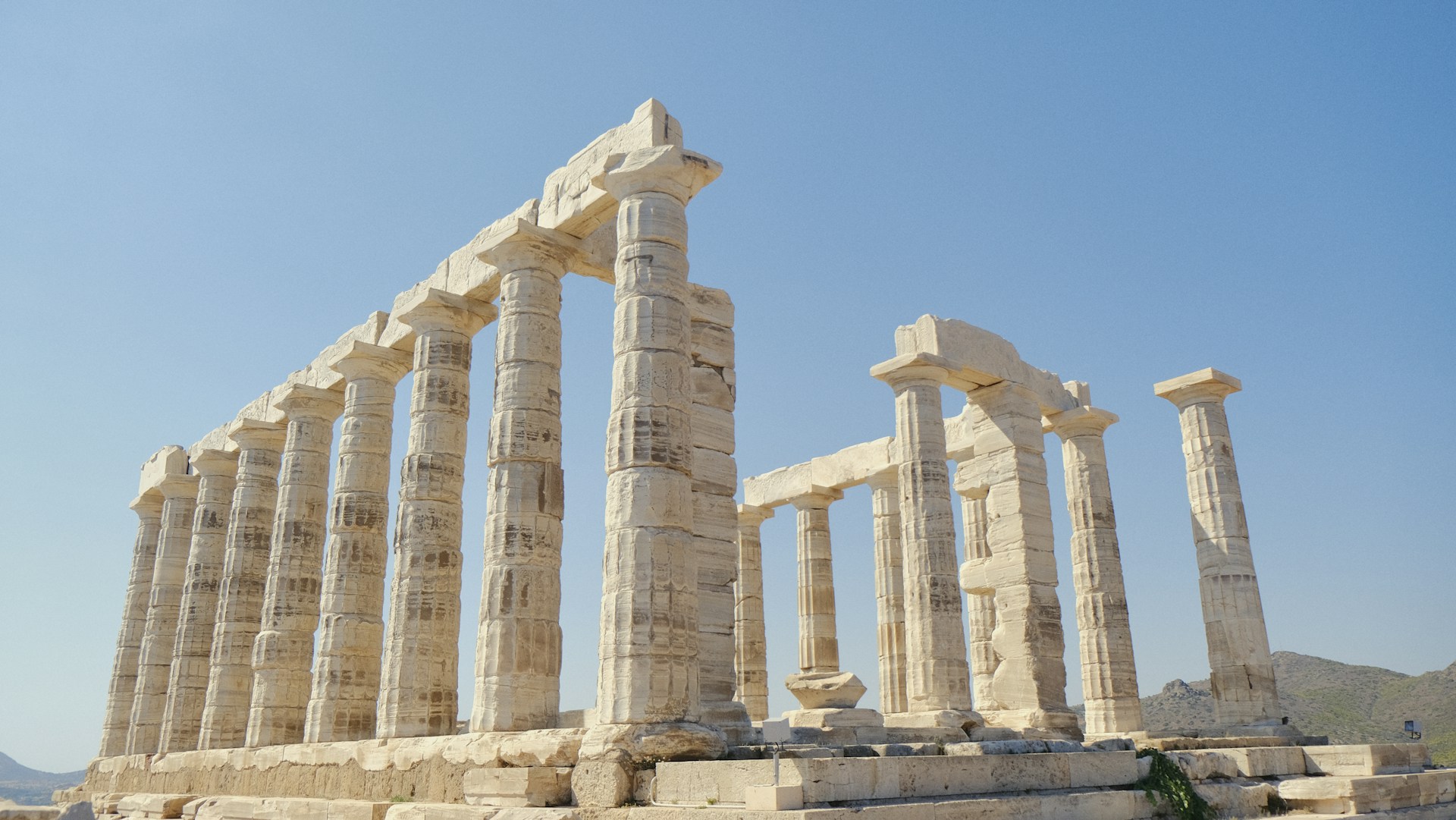 A group of stone pillars sitting on top of a field