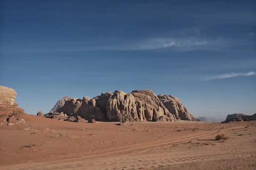 A large rock formation in the middle of a desert