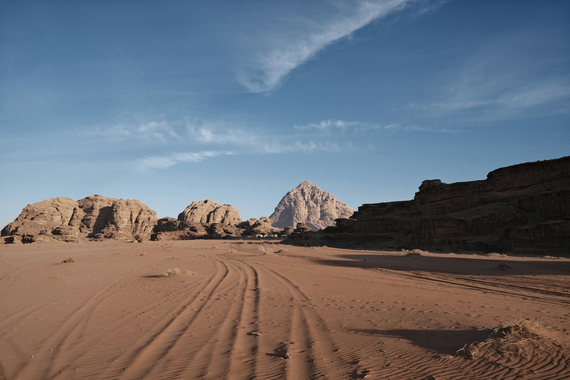A desert landscape with rocks and a blue sky