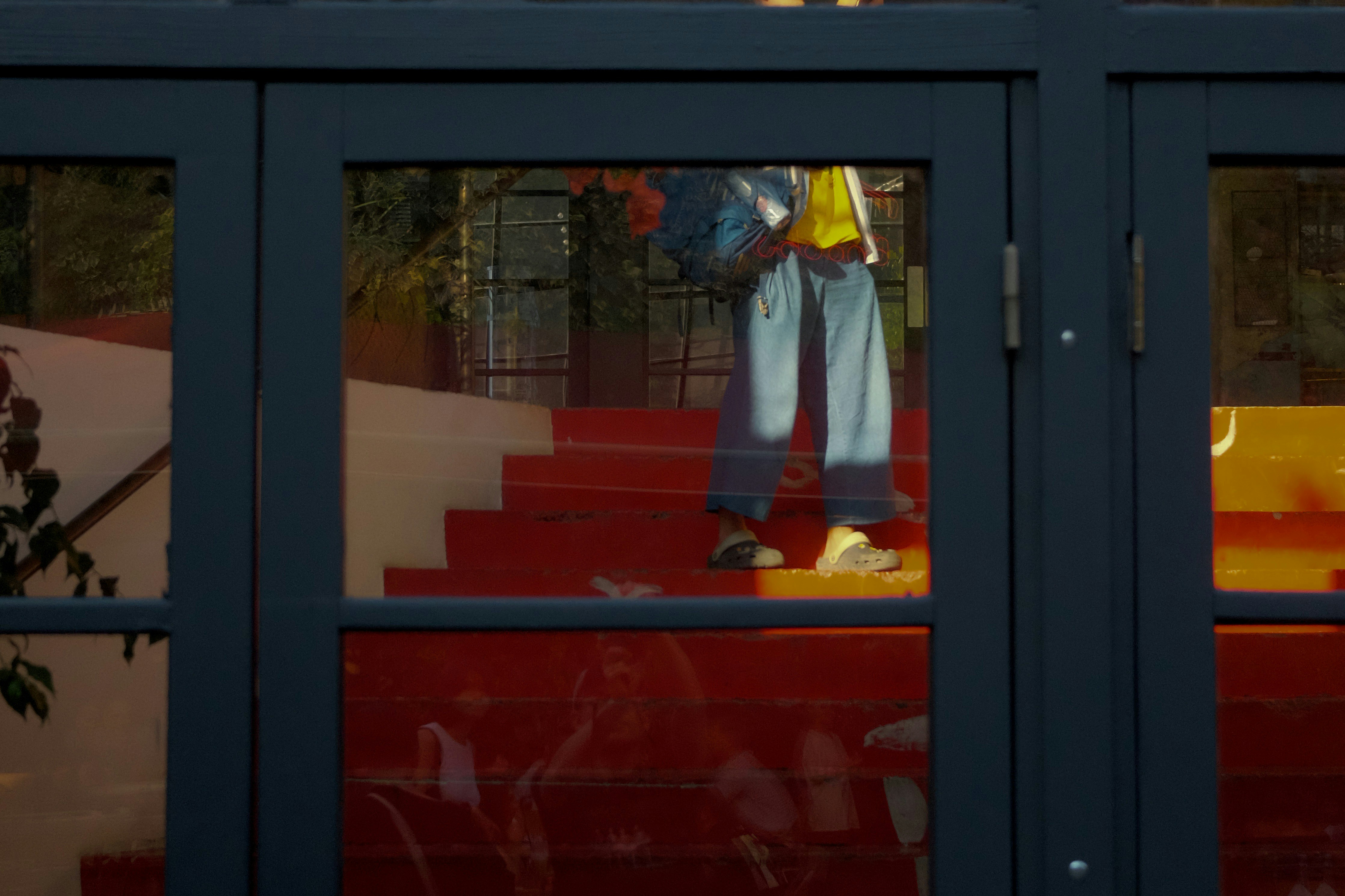 A reflection of a person in a window