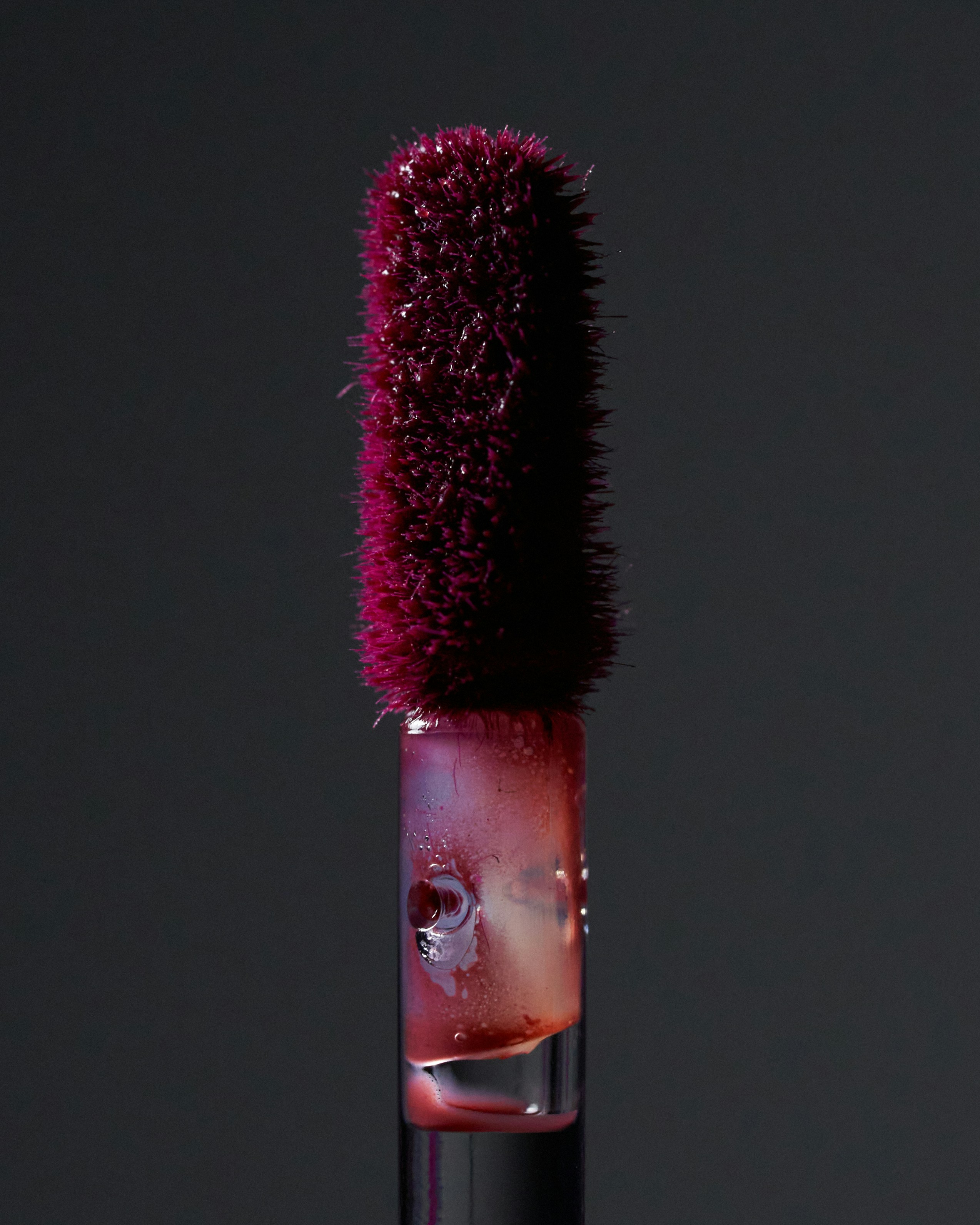 A close up of a bottle with a brush in it