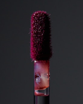 A close up of a bottle with a brush in it
