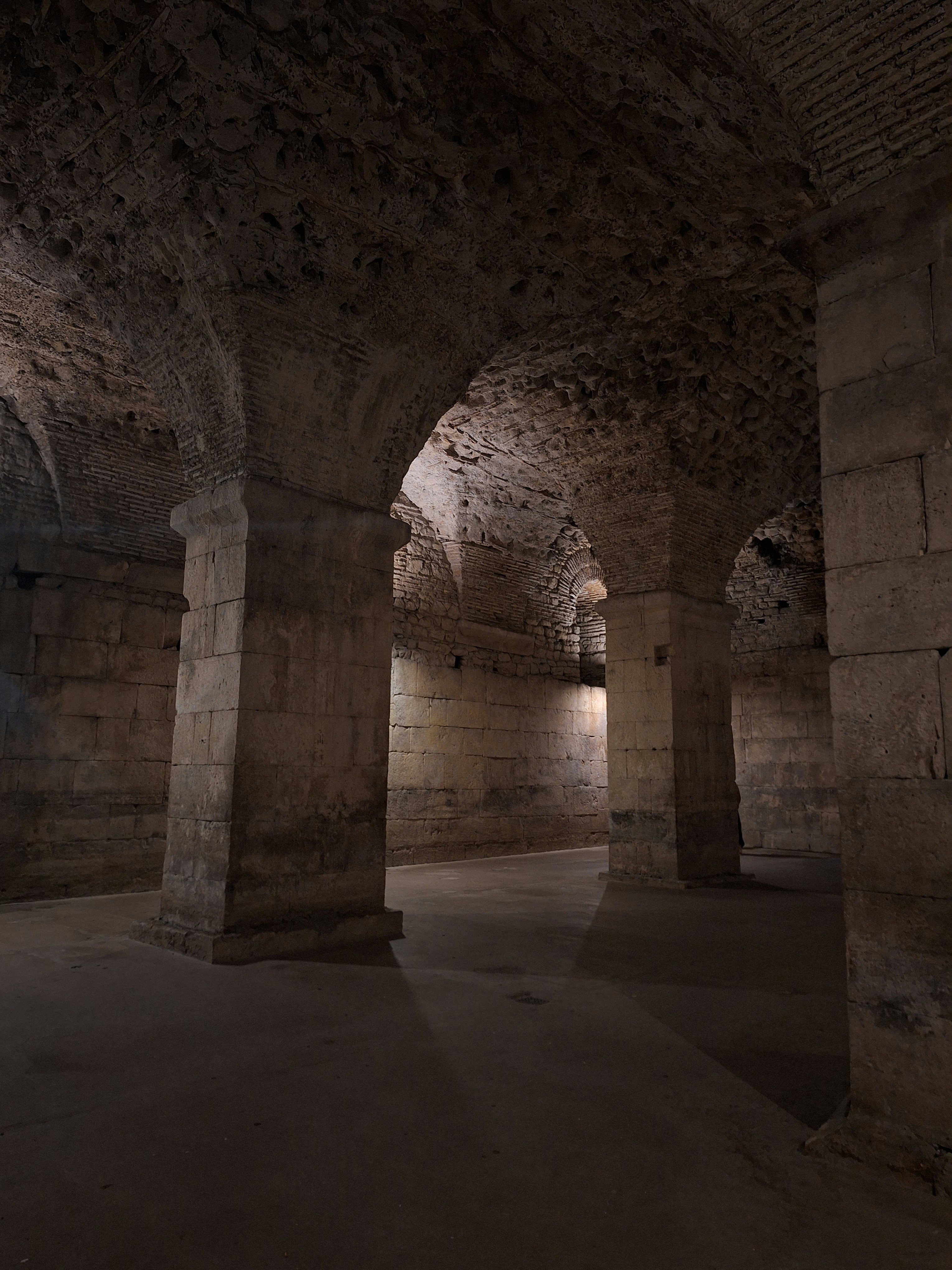 A dimly lit tunnel in a stone building