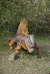 A statue of a dinosaur laying on its back
