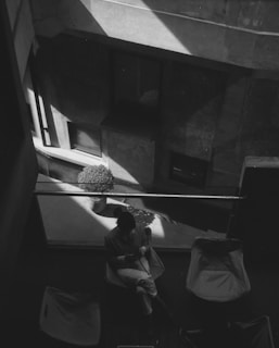 A black and white photo of a person sitting in a chair