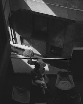 A black and white photo of a person sitting in a chair