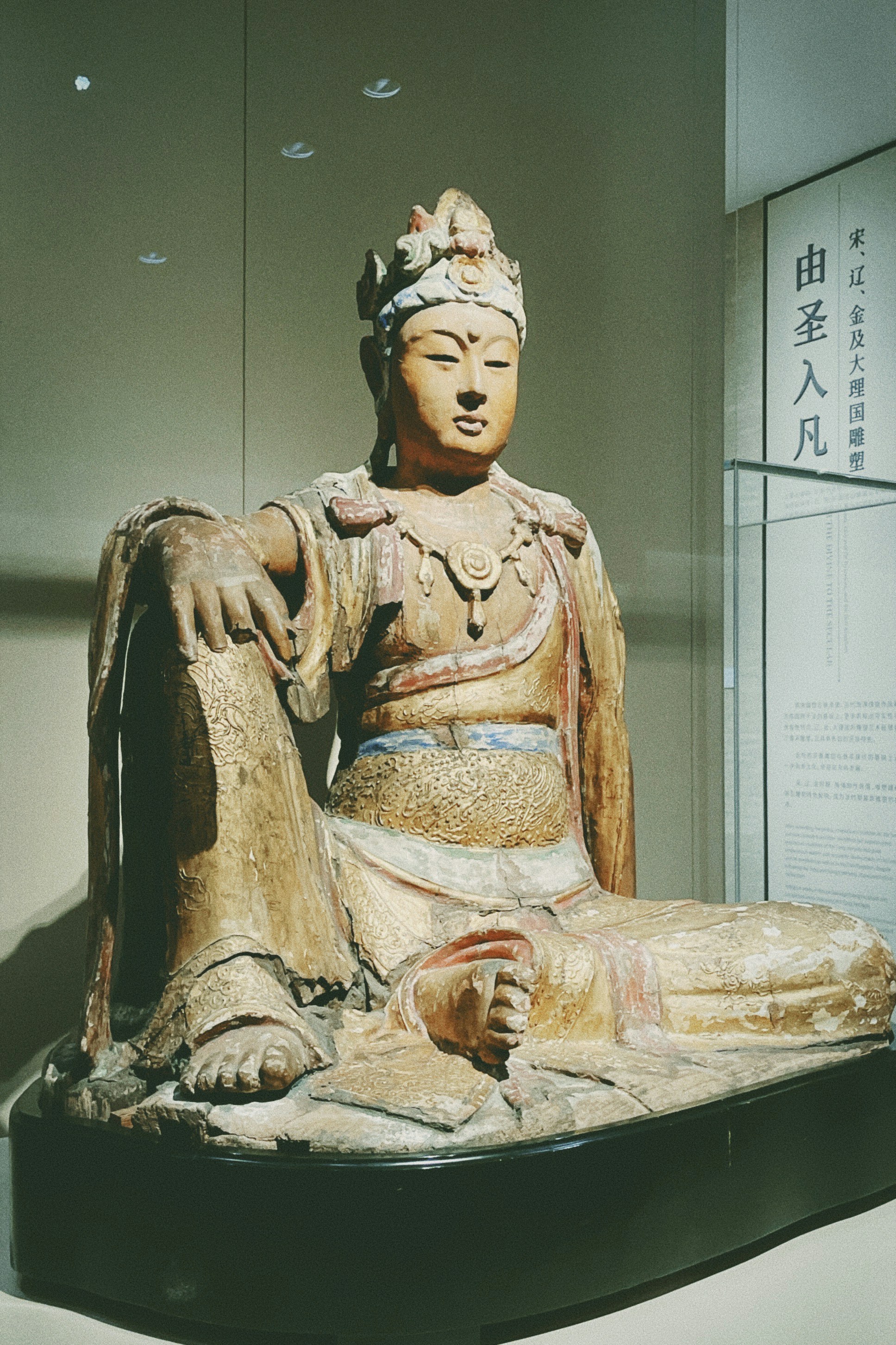 A statue of a seated buddha in a museum