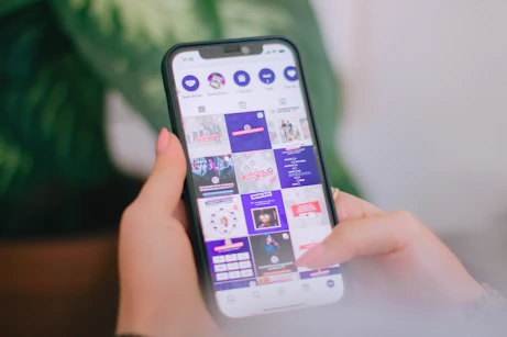 A person holding a cell phone in their hand