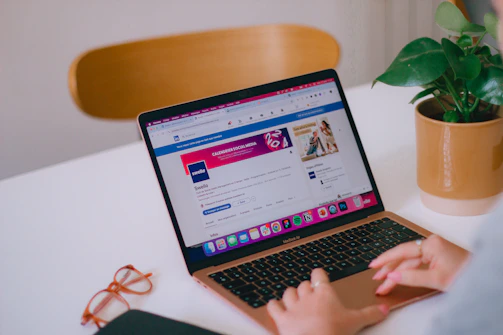 A person sitting at a desk with a laptop