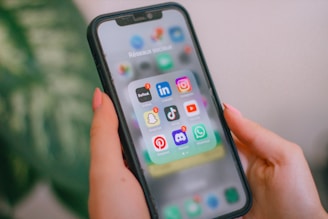 A person holding a cell phone in their hand