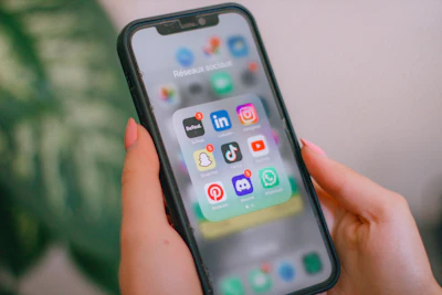 A person holding a cell phone in their hand