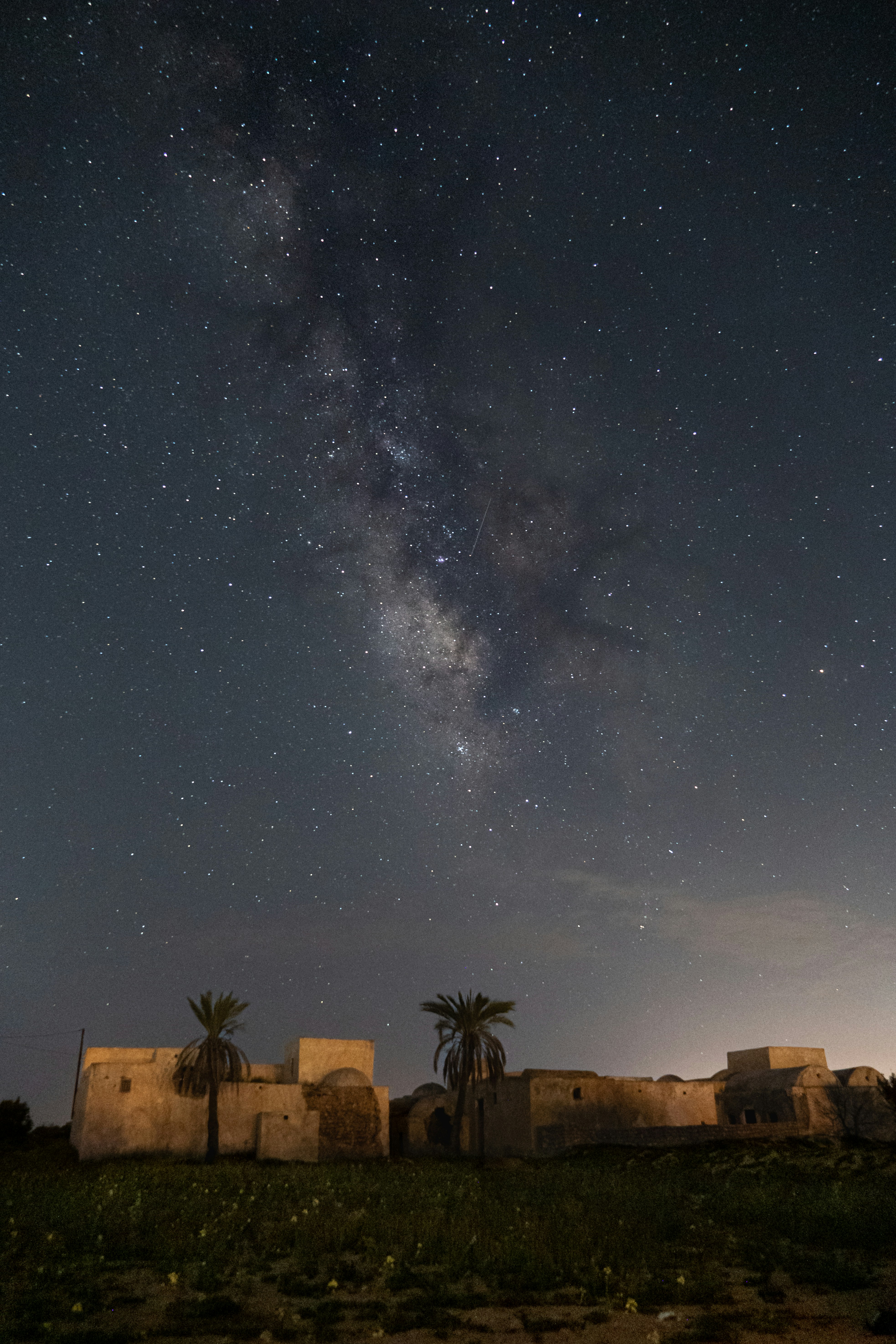 The night sky with stars above a small village