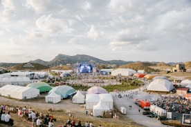 A large group of people standing around tents