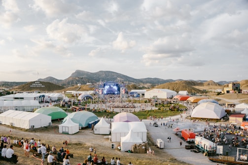 A large group of people standing around tents