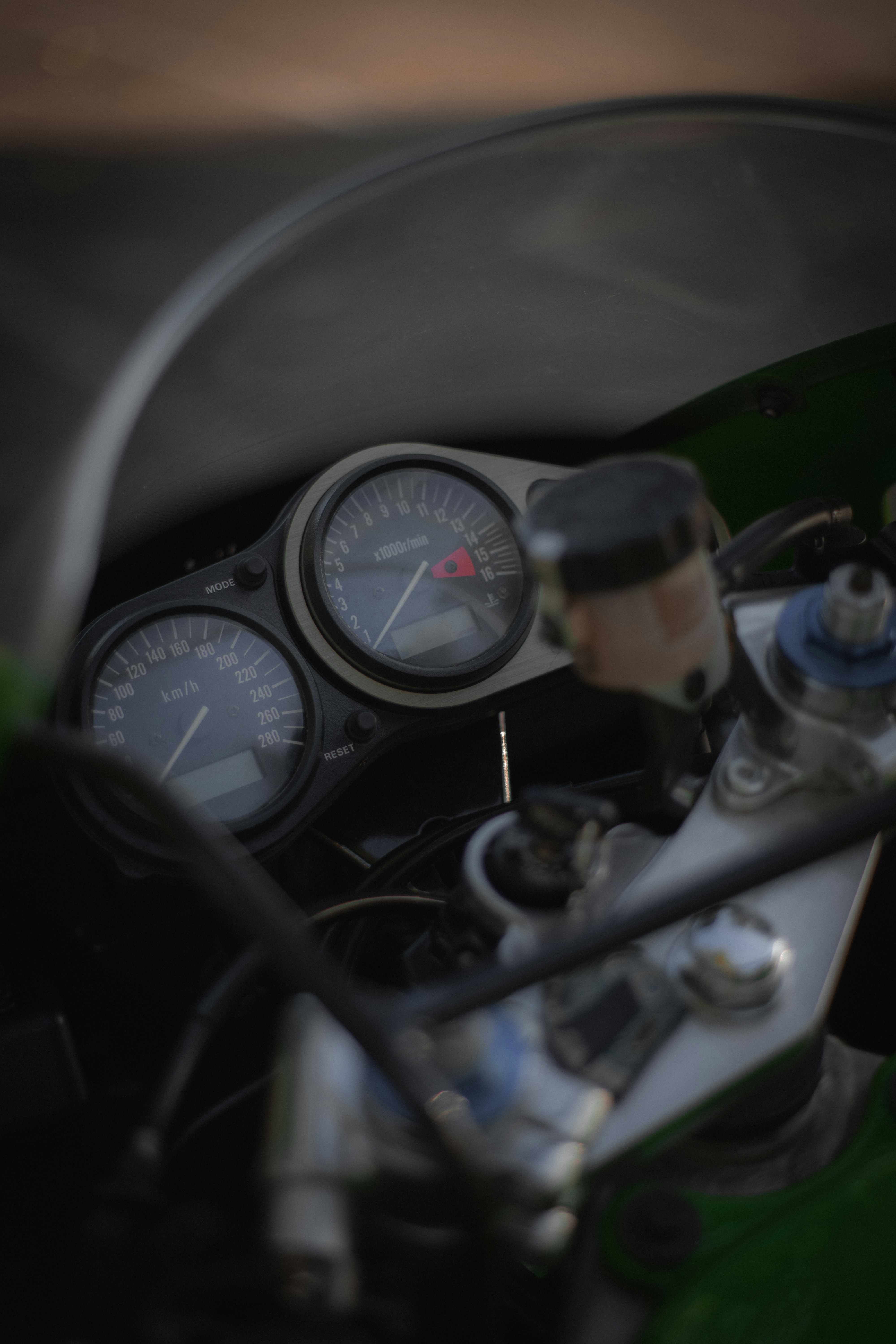 A close up of a motorcycle with a speedometer