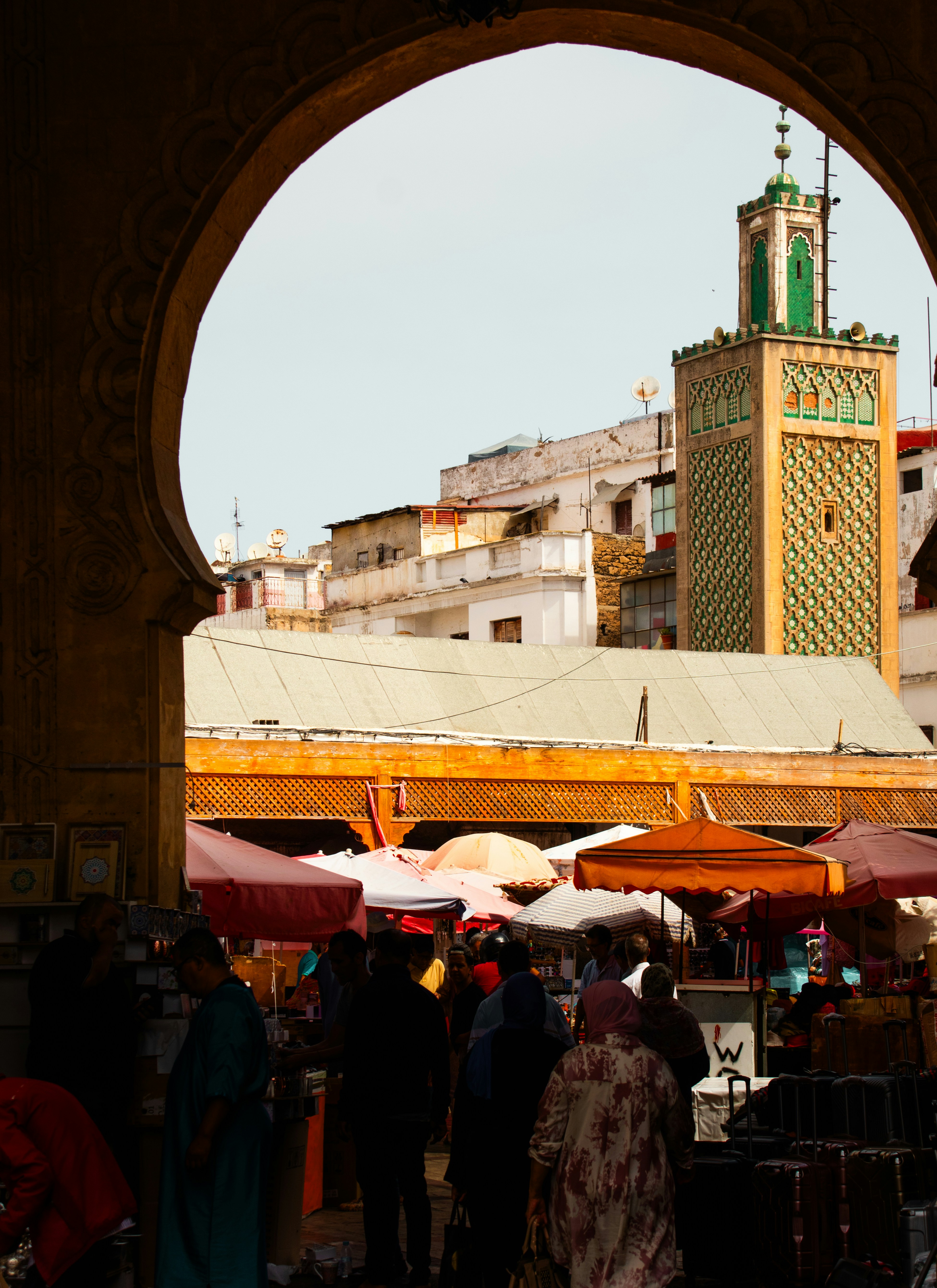 A group of people standing around a market