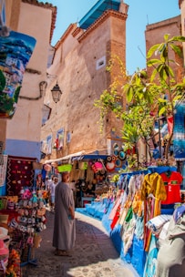 A man is walking through a street market