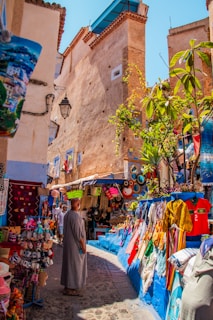 A man is walking through a street market