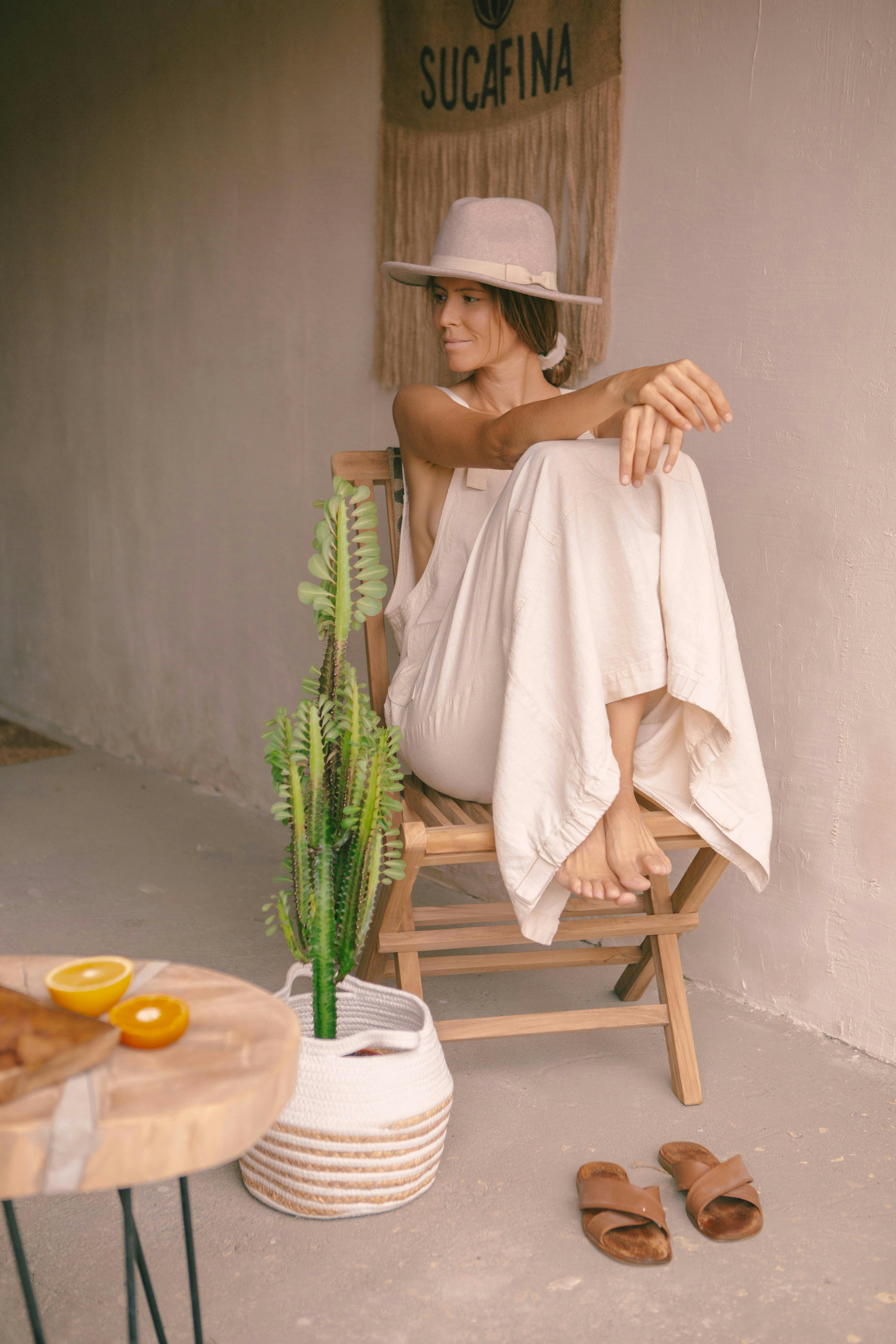 A woman in a white dress sitting in a chair