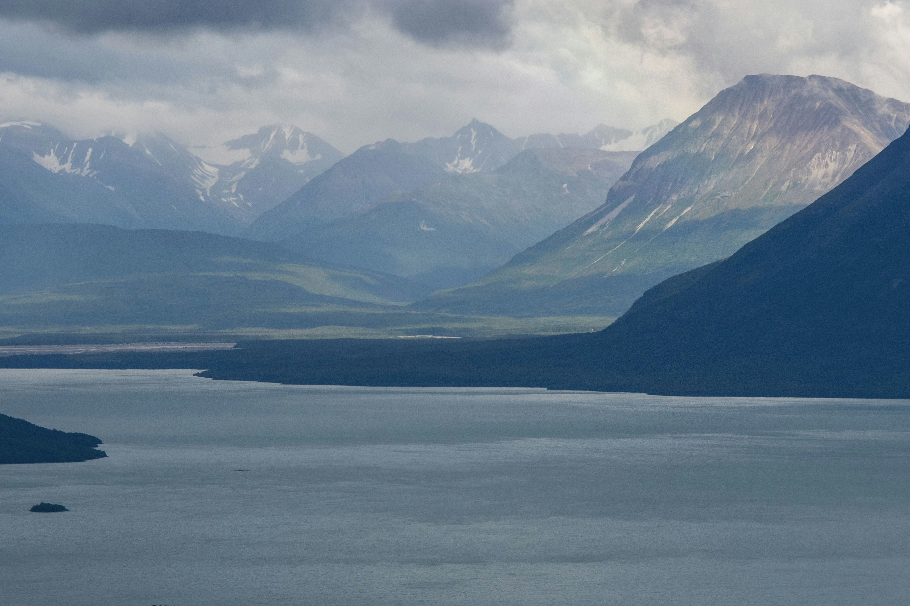 A large body of water surrounded by mountains