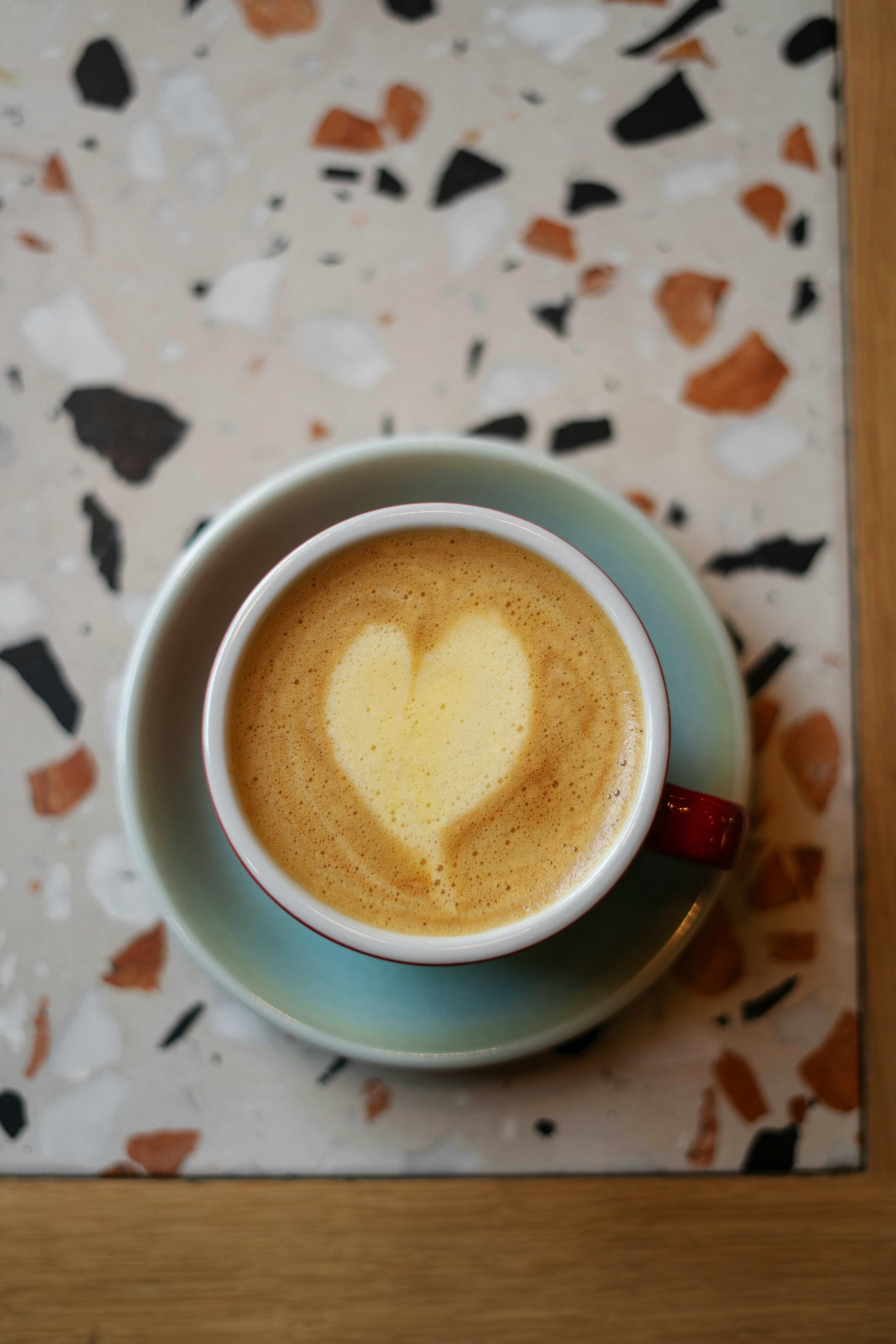 A cup of coffee with a heart in it