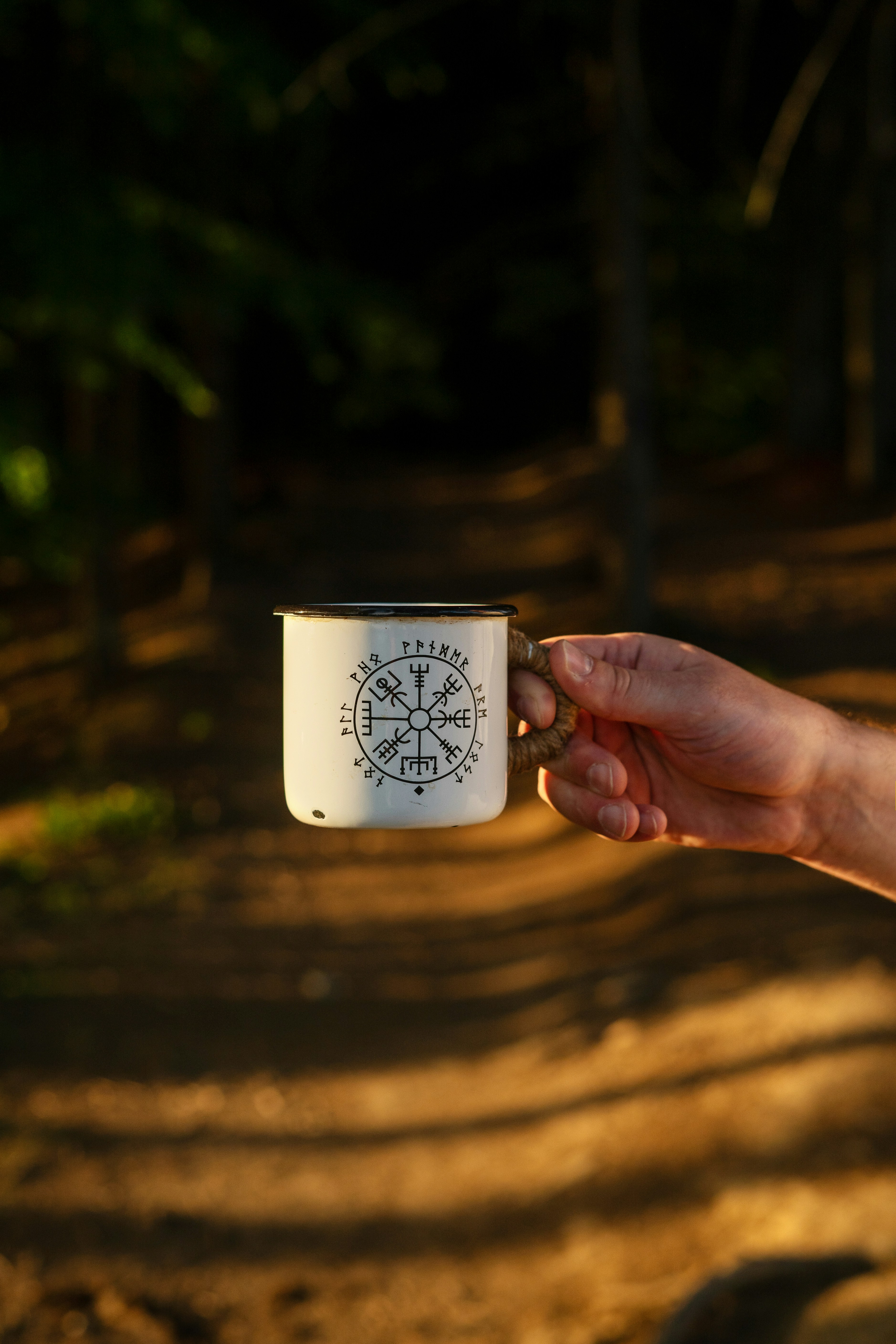 A person holding a coffee mug in their hand
