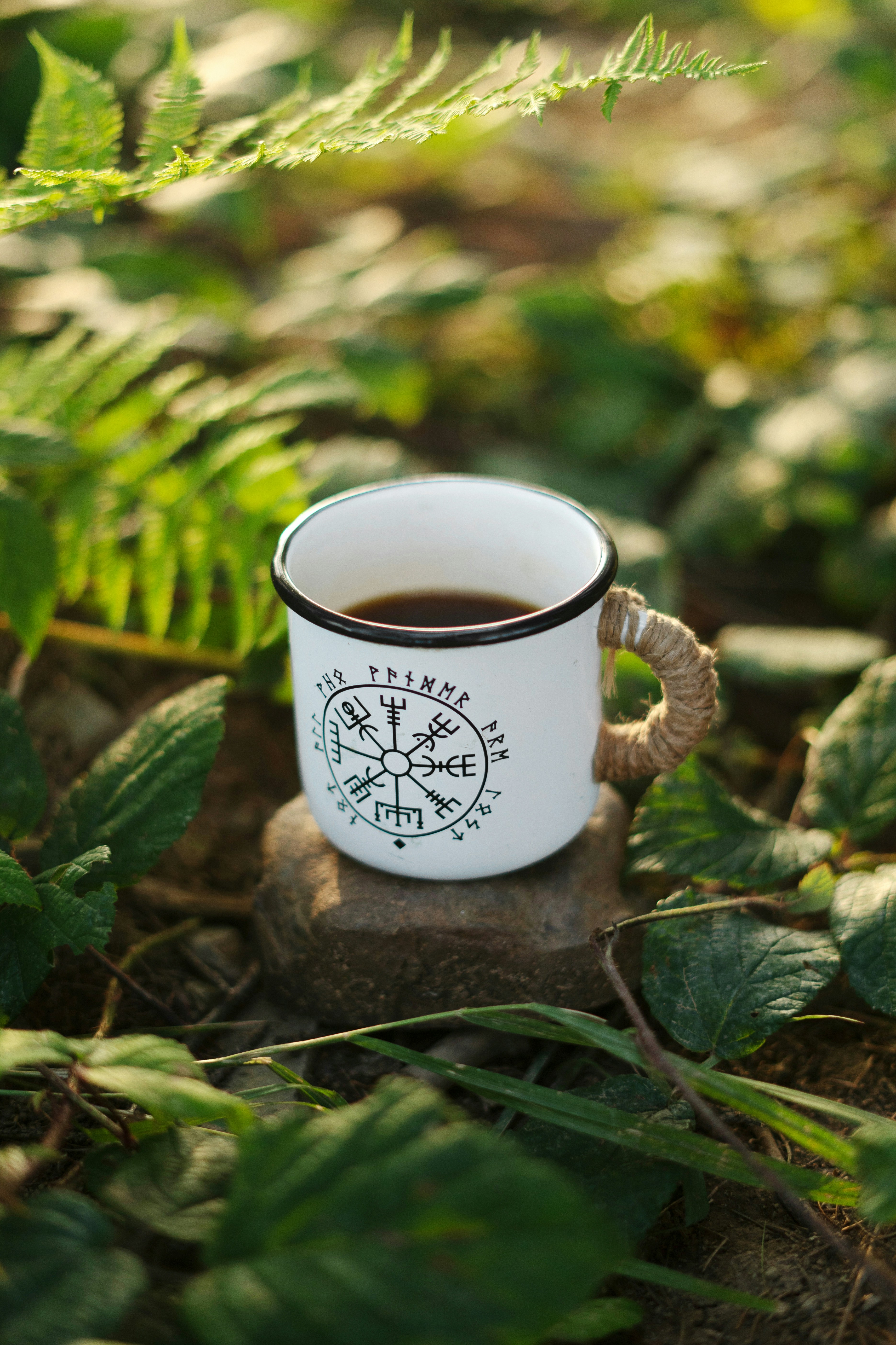 A cup of coffee sitting on top of a rock