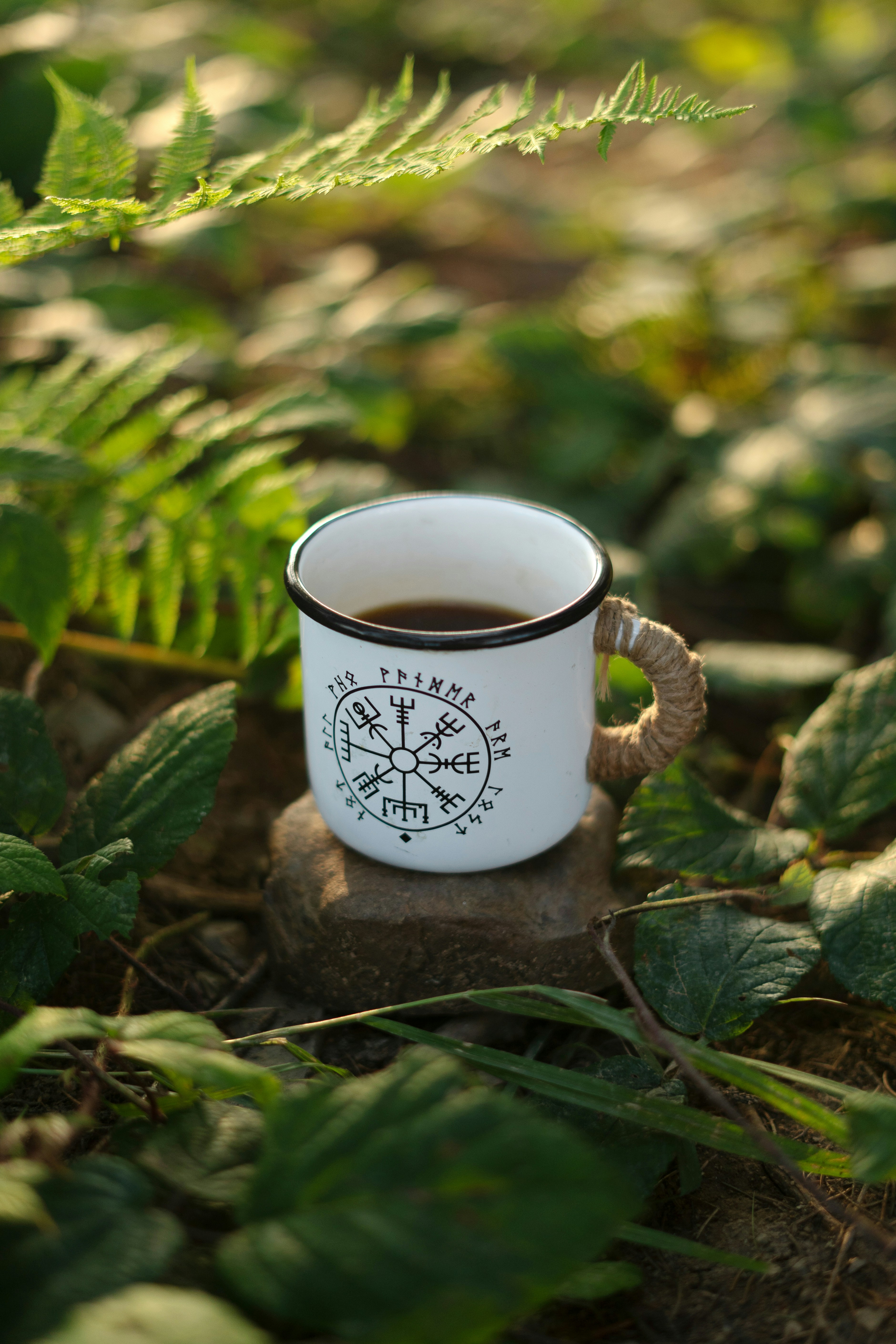 A cup of coffee sitting on top of a rock