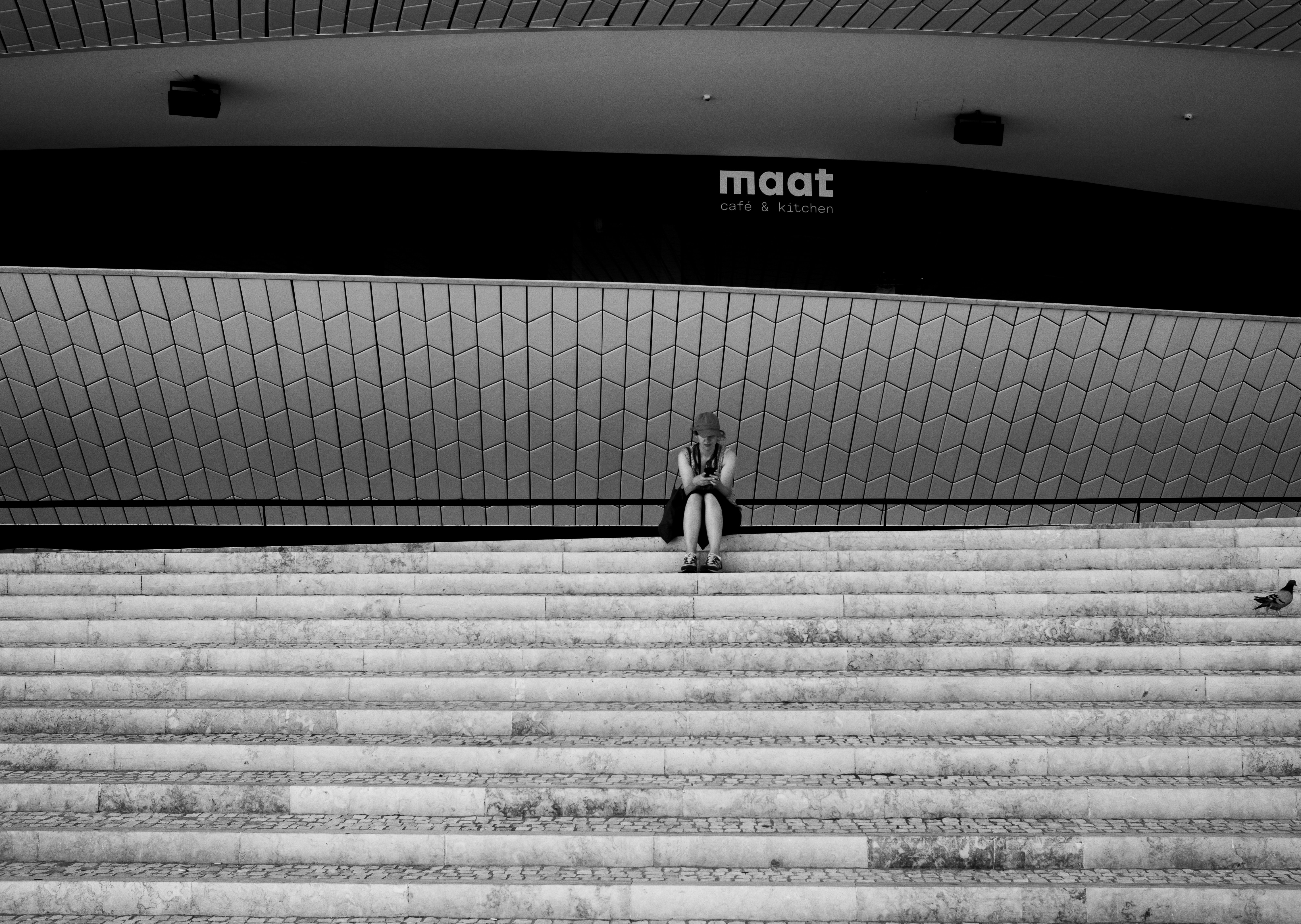 lone pedestrian under archways