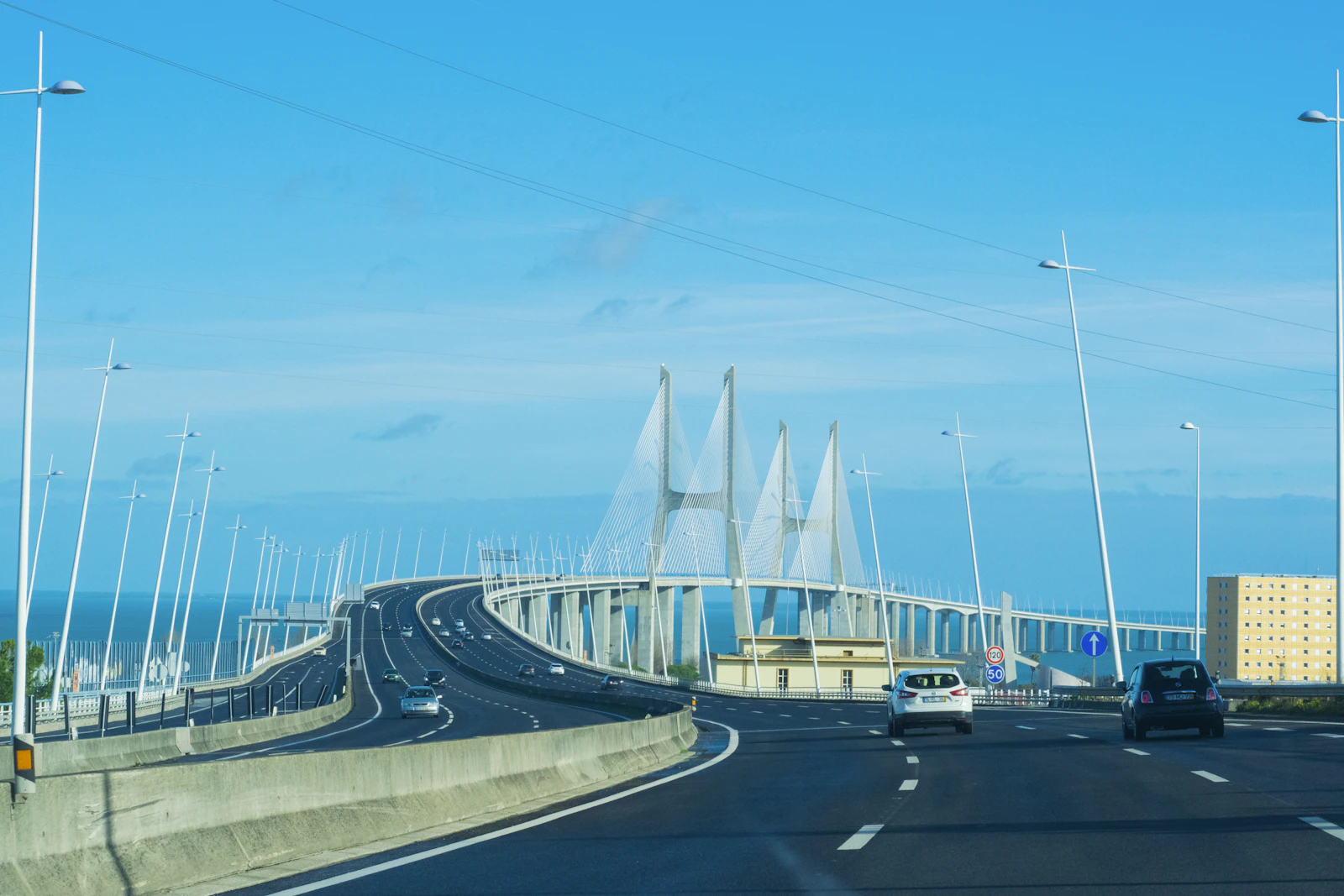 Cars approach the Vasco da Gama Bridge near Lisbon