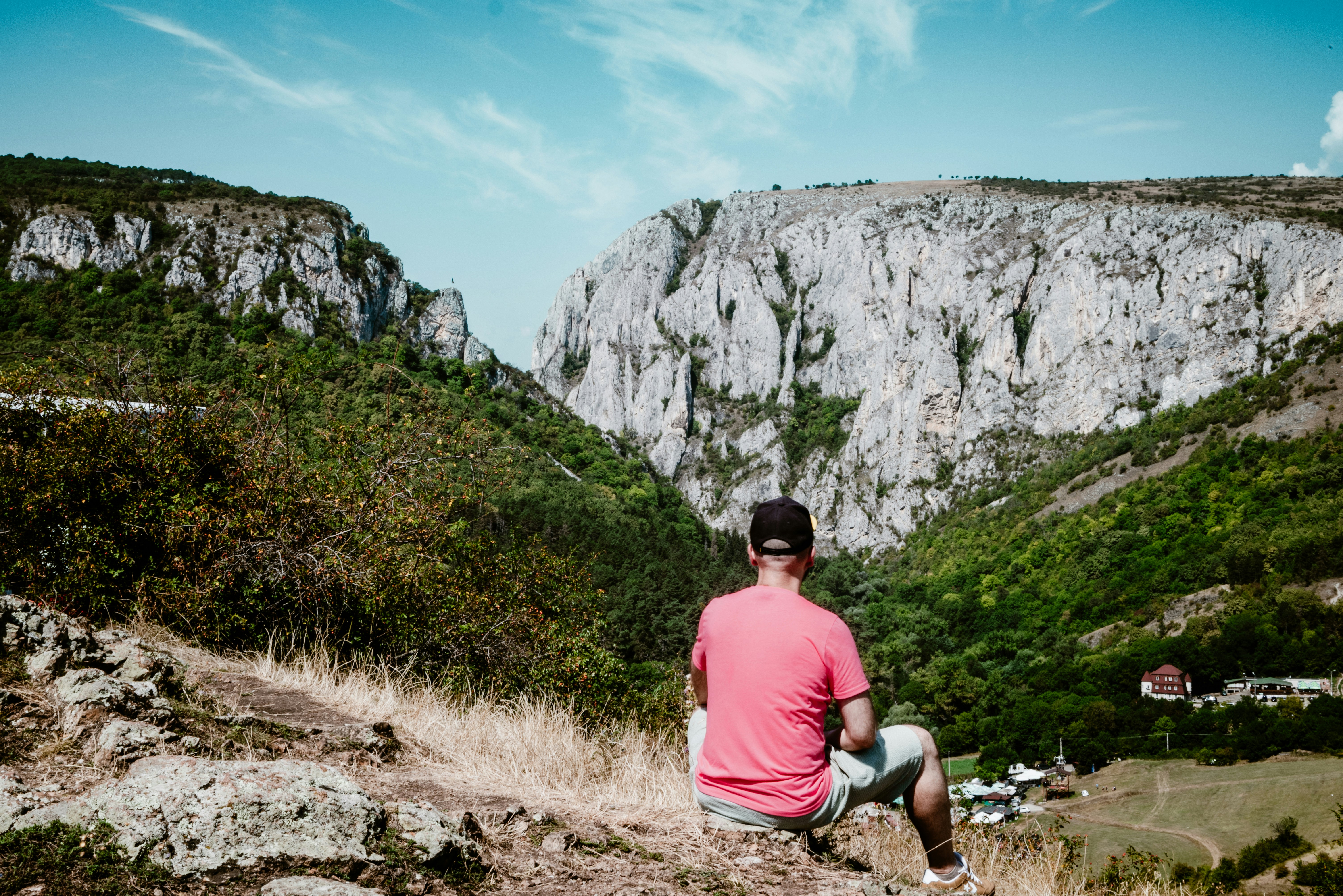 A serene moment as an individual admires the majestic cliffs of Cheile Turzii in Romania.