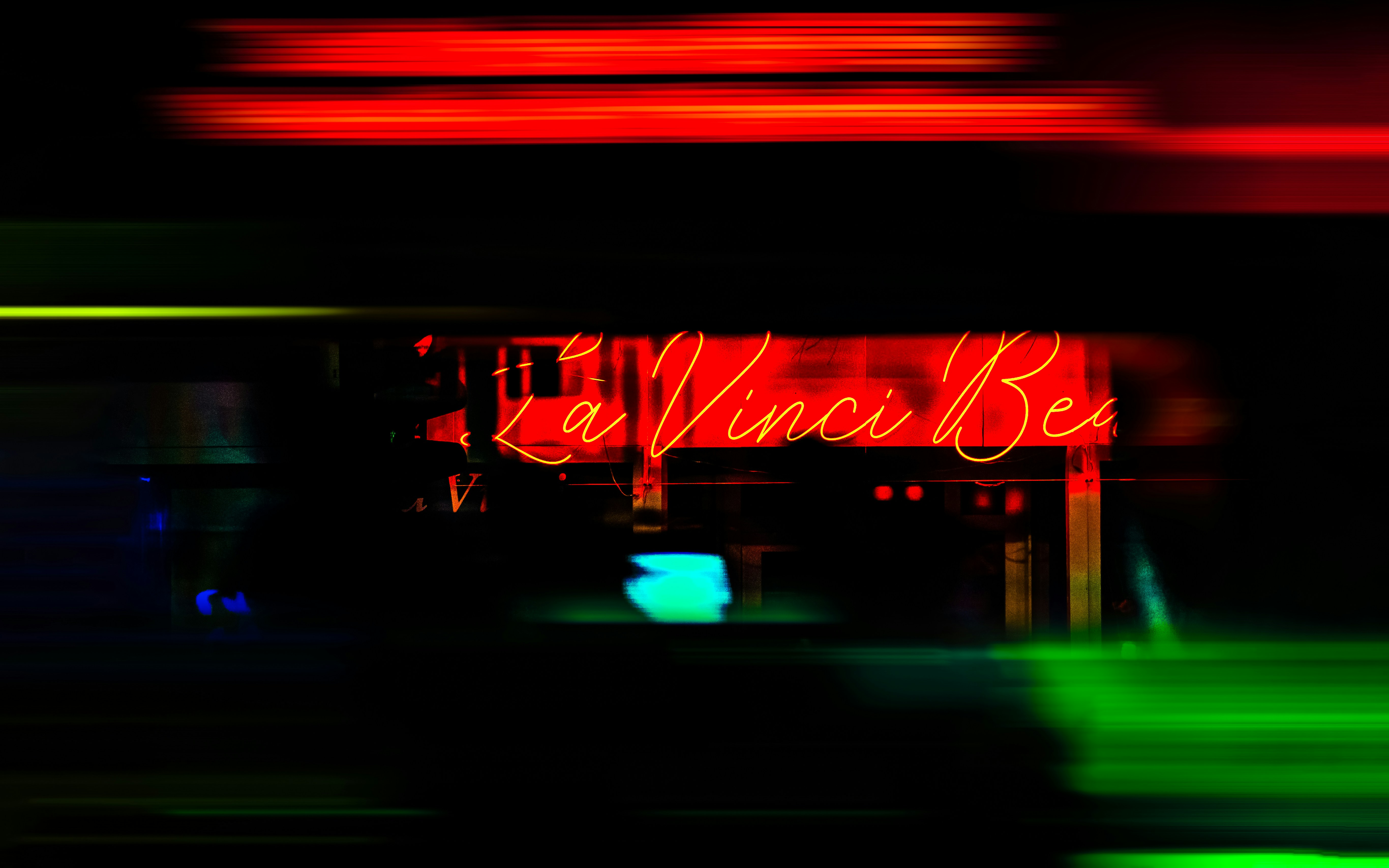 A blurry photo of a neon sign in the dark