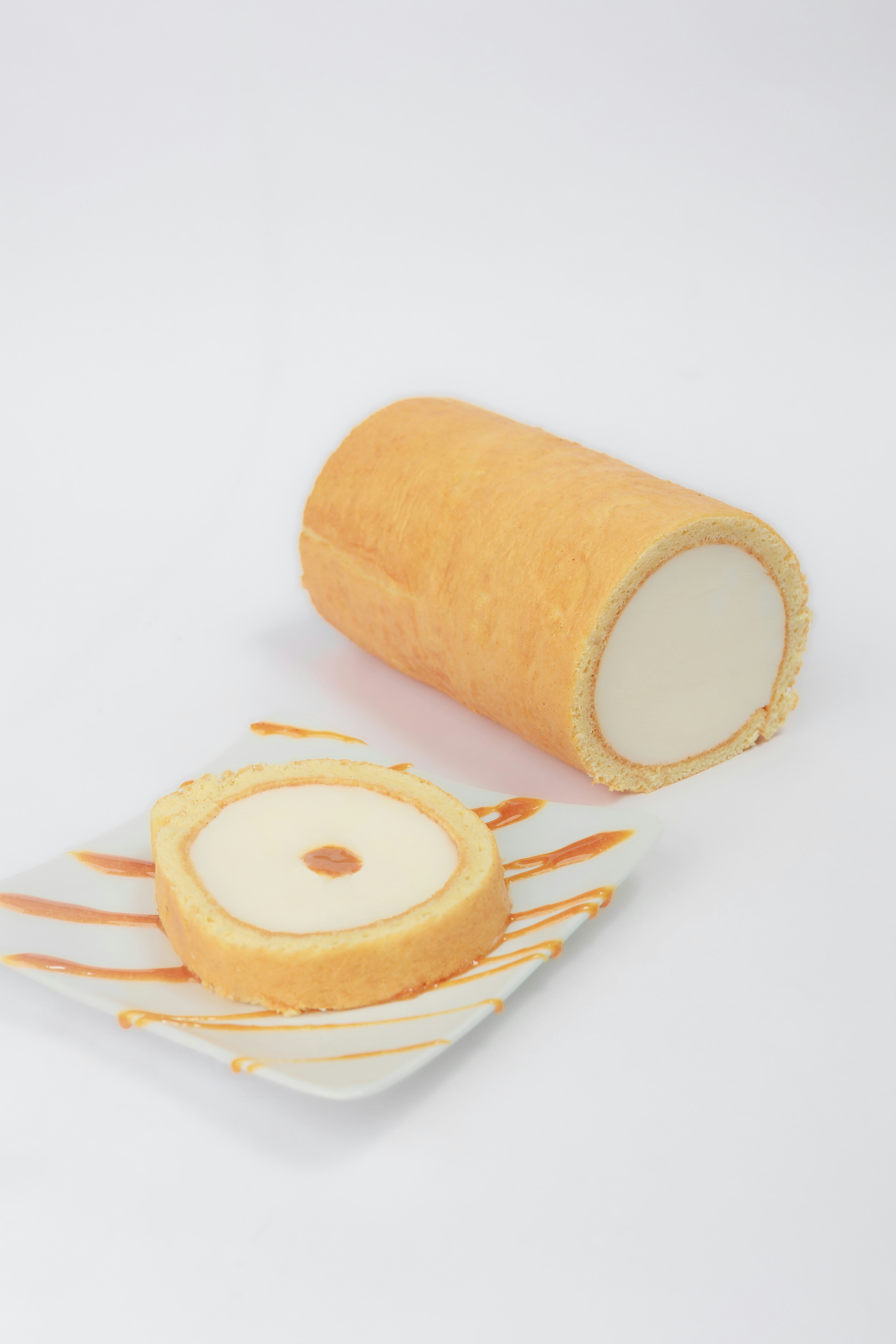 A roll of orange tape sitting on top of a white plate photo Free Food