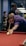 A man leaning over a pool table with a cue in his hand