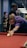 A man leaning over a pool table with a cue in his hand
