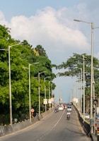 A street filled with lots of traffic next to trees