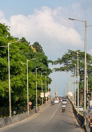 A street filled with lots of traffic next to trees