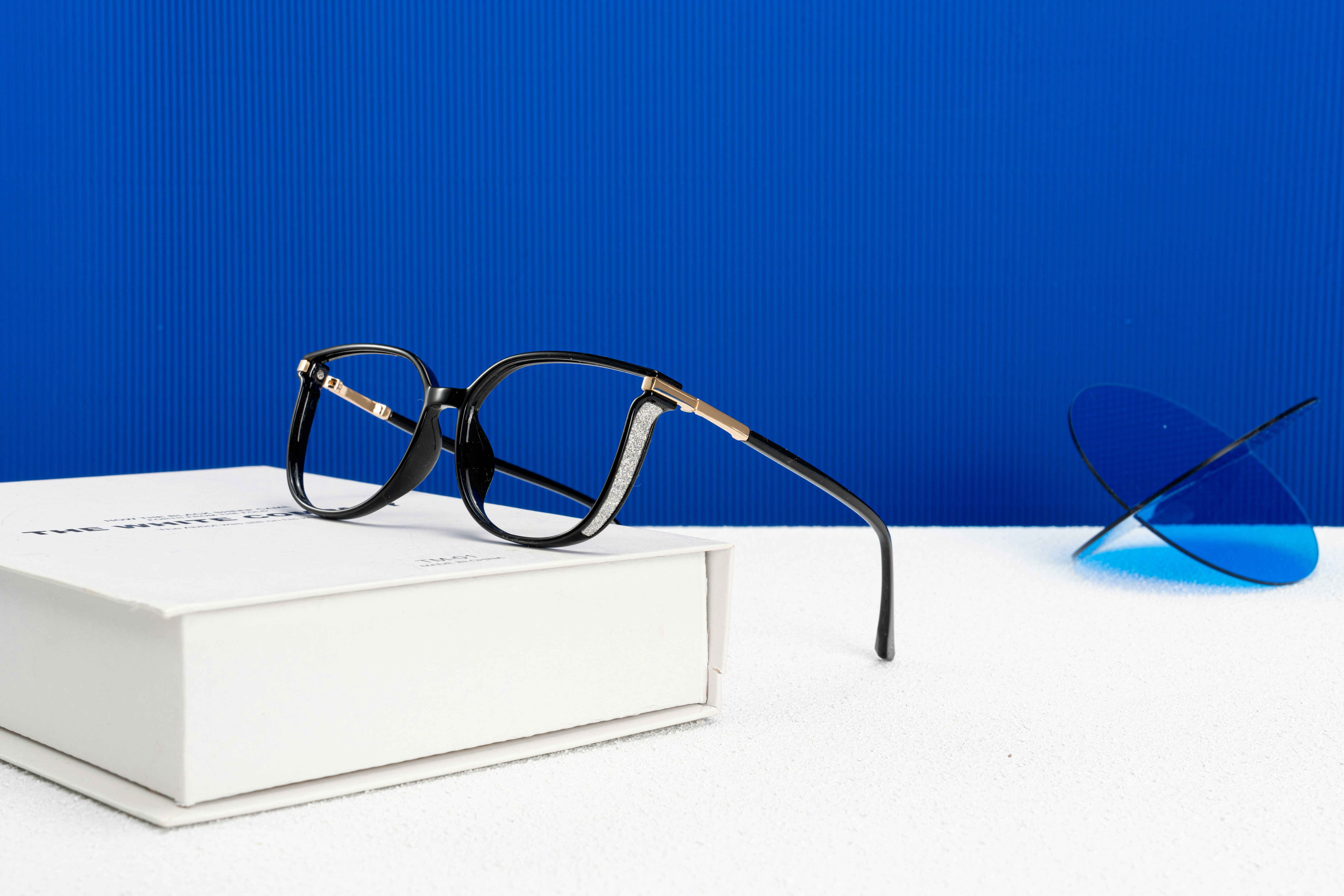 A pair of glasses sitting on top of a box