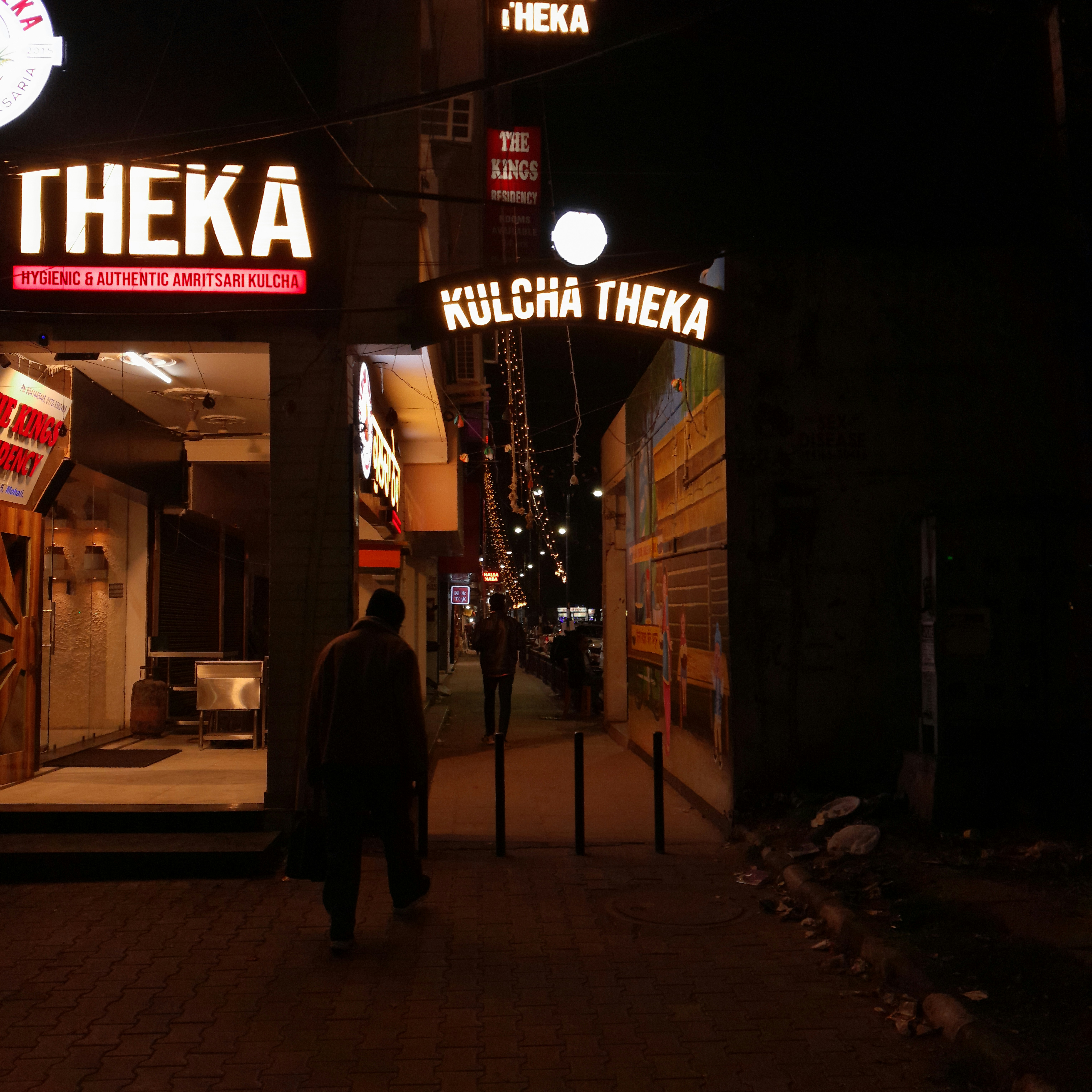 A man walking down a street at night
