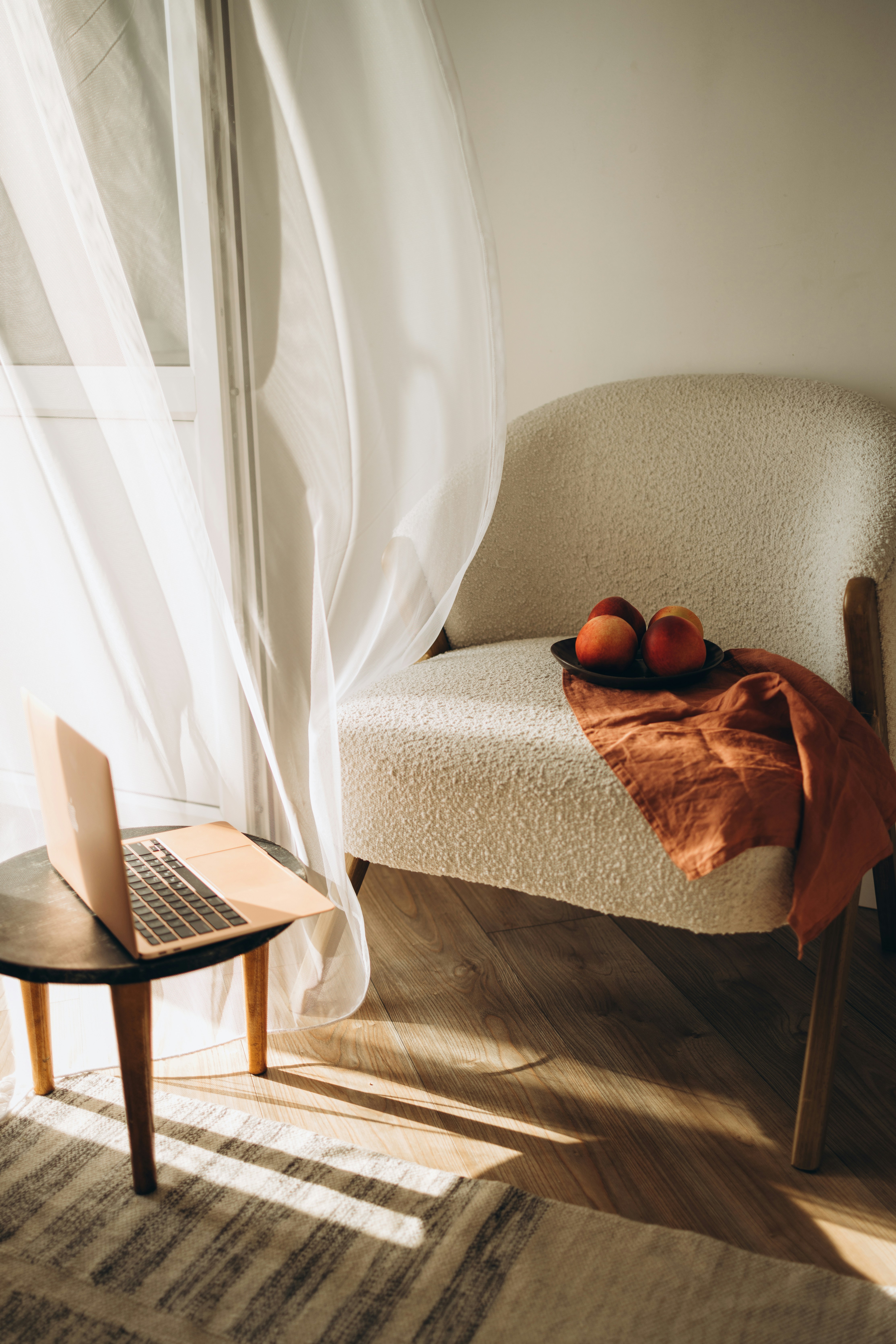 A laptop computer sitting on top of a wooden tableby Katie Azi