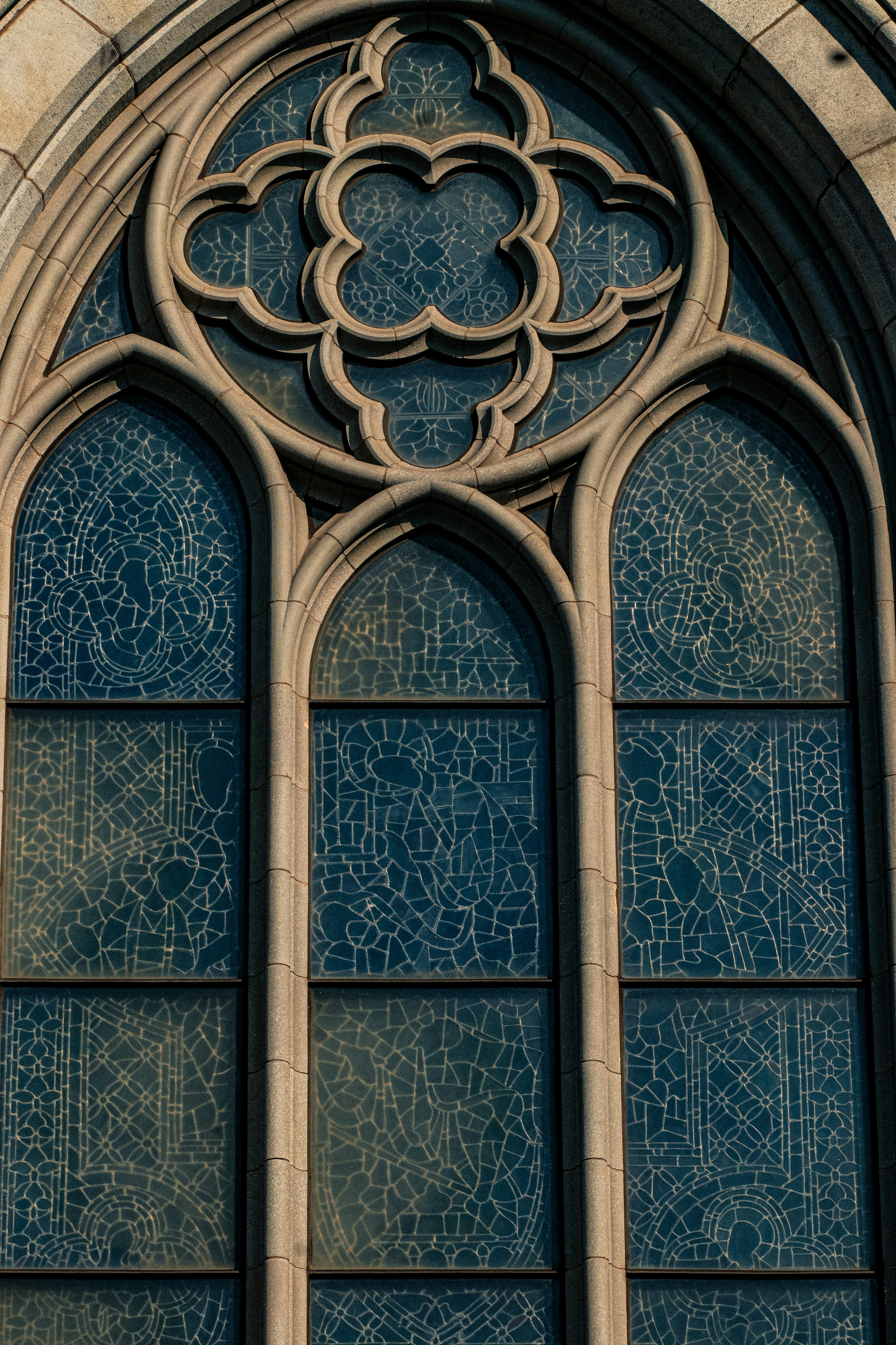 A large stained glass window in a stone building