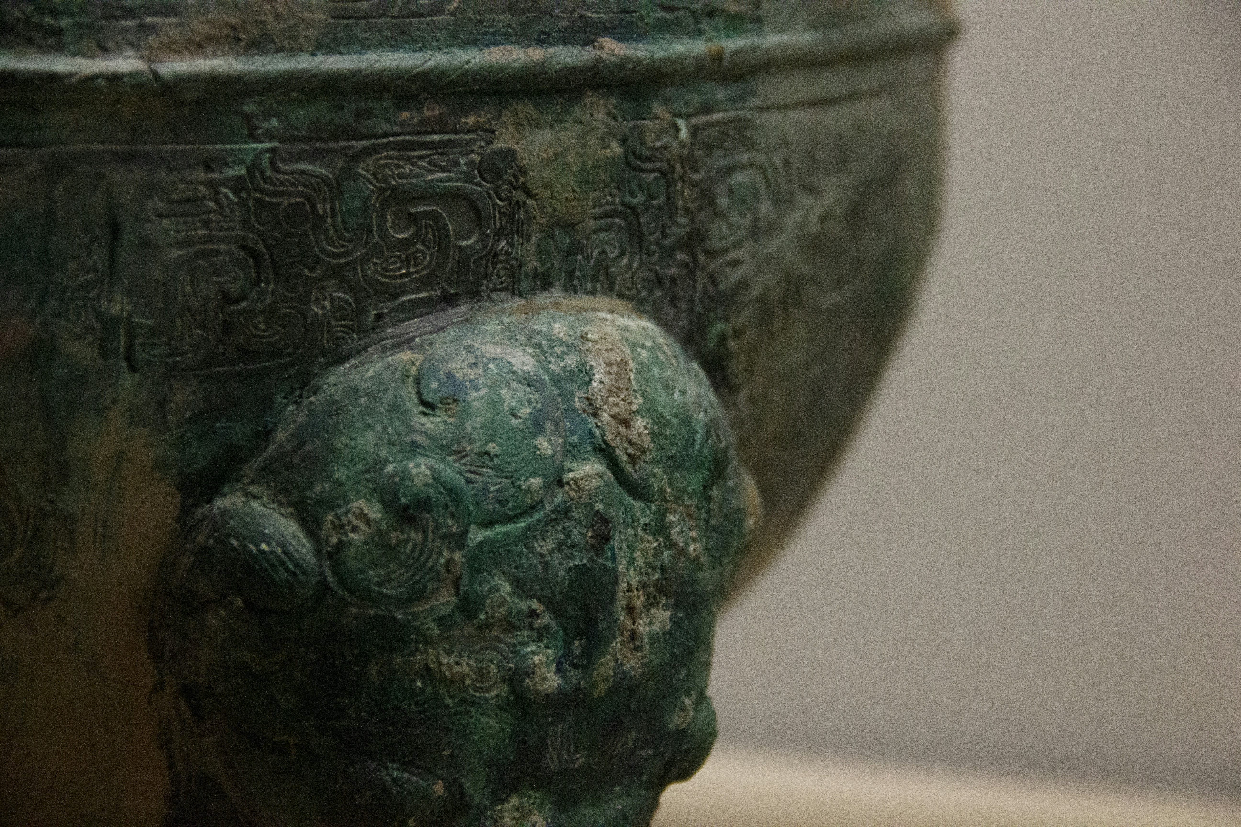Detail of a bronze tribal artifact showing patina