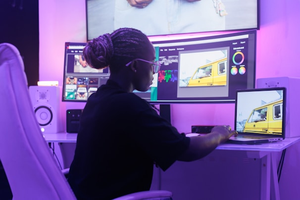 A woman sitting in front of a computer monitor