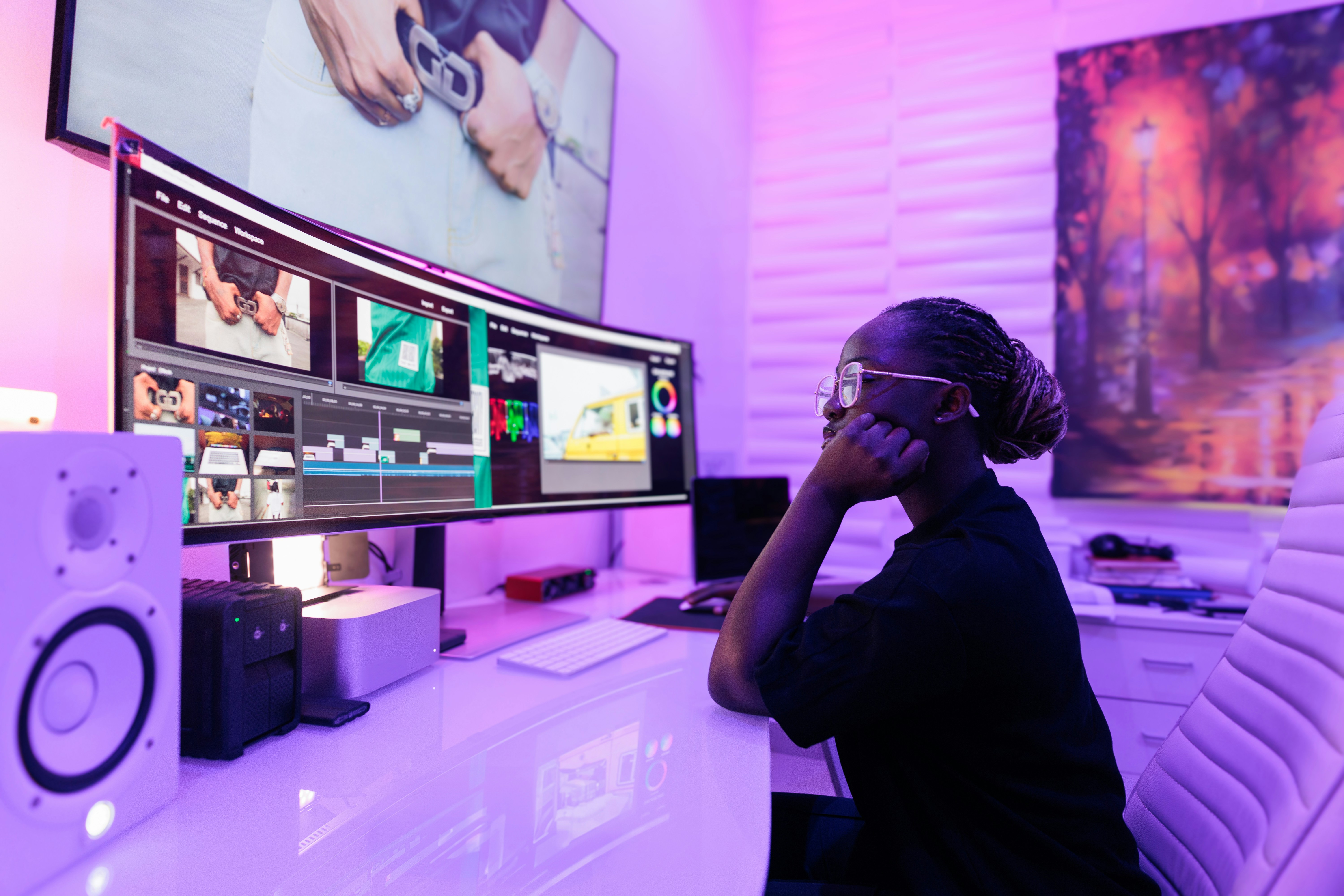 After having audio formats explained to her, a creator chooses the best audio format for editing, using a lossless audio format as she edits video on a dual monitor