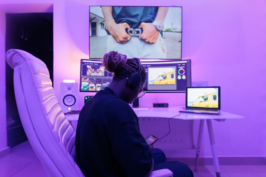 A woman sitting in front of a computer monitor,